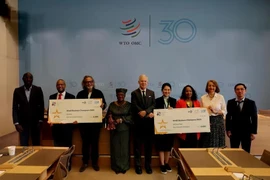 Minister Counsellor Pham Quang Huy (far right) pictured with the organizers of the 2025 Small Business Champions Competition. (Photo: VNA)