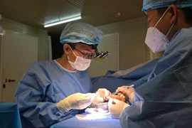 Vietnamese surgeons working on the injured finger. (Photo courtesy of FHL 2.6.)