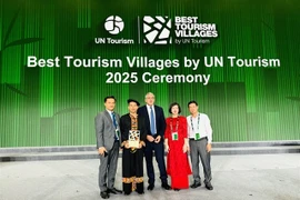 Representatives of Tuyen Quang province and organising committee pose for photo after Lô Lô Chải is honoured one of best tourism villages in 2025. — (Photos courtesy of Tuyen Quang province) 