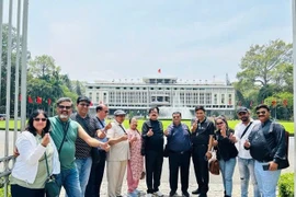 Indian tourists pose for in front of Independence Palace, HCM City (Photo: VNA)