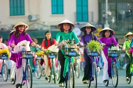 Women participate in the “Ao dai connecting Hanoi tourism and heritage” programme in 2023. (Photo: VNA) 