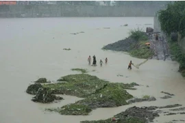 A man throws a fishing net along a swollen river following tropical storm Wipha fueled monsoon rains in Marikina, Philippines on July 22. (Photo: AP) 