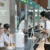 Patients register at the reception desk upon arrival for medical examination. (Photo: VNA)
