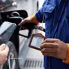 A buyer is making cashless payment at a petrol station. (Photo: VNA)