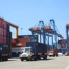Container trucks operate at Gemalink International Port, part of the Cai Mep Port system in Ho Chi Minh City. (Photo: VNA)