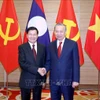 General Secretary of the Communist Party of Vietnam To Lam (right) and General Secretary of the Lao People’s Revolutionary Party and President of Laos Thongloun Sisoulith at a meeting during the Lao leader's visit to Vietnam. (Photo: VNA)