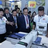 Delegates visit a booth at the exhibition (Photo: VNA)
