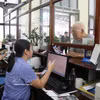 Staff at Hai Phong Railway Station assist passengers with ticket purchase procedures (Photo: VNA)