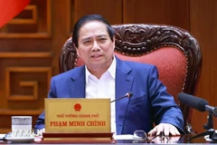 PM chairs a meeting to draft resolutions on breakthroughs in health care, education. (Photo: VNA)