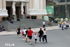Visitors stroll around Lam Son Square in front of the Ho Chi Minh City Opera House. (Photo: VNA)