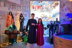 A showcase of the traditional Ao dai ngu than, modeled by staff from the Vietnam Pavilion and representatives from other pavilions participating in EXPO 2025, including the US, Switzerland, and others. (Photo: Ministry of Culture, Sports and Tourism)