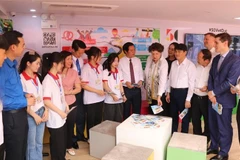 Delegates explore the career-orientation-bus programme. (Photo: VNA)