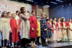 Vietnamese and French children perform the song "Bonjour Vietnam" at the festival. (Photo: VNA)