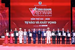 Head of the Party Central Committee’s Commission for Information, Education and Mass Mobilisation Nguyen Trong Nghia (seventh from left), and President of the Vietnam General Confederation of Labour Nguyen Dinh Khang (eighth from left) present the Glory to Vietnam 2025 emblems and certificates to the honoured collectives. (Photo: VNA)