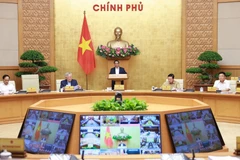 Prime Minister Pham Minh Chinh chairs the regular June cabinet meeting and the national online conference between the Government and local authorities. (Photo: VNA)