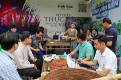 Visitors explore information about the Quintessence of Tonkin programme at the 2025 Hanoi Tourism Festival. (Photo: VNA) 