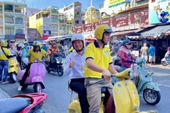Tourists enjoy exploring Ho Chi Minh City by Vespa. (Photo: VNA)