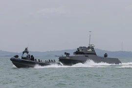 Singapore Navy's new maritime security unmanned surface vessel (right) chasing a suspicious vessel during a demonstration at Changi Naval Base on February 4. (Photo: The Strait Times)