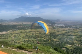 A paraglider takes off on Phung Hoang Mountain in An Giang province’s Tri Ton district. (Photo: VNA)