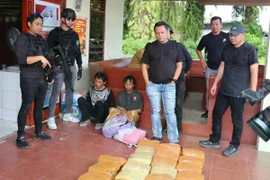 Two suspects arrested in the smuggling of 74 kilograms of marijuana by an inter-provincial network from Mandailing Natal District-Jakarta in West Pasaman District West Sumatra, Indonesia on February 16. (Photo: Antara)