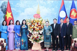 A delegation of the Vietnam Women’s Union extends congratulations to the Lao Embassy in Vietnam on the 50th anniversary of National Day of Laos. (Photo: hoilhpn.org.vn)