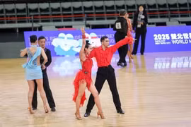 Vietnamese Pham Trung Hoa - Nguyen My Trang (in red) dance for their gold medal in the World Master Games's event on May 28 in Chinese Taipei. 