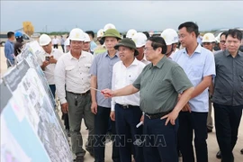 Prime Minister Pham Minh Chinh inspects the construction of the Quang Tri Airport Urban–Aviation Industrial Complex Project, July 26. (Photo: VNA)
