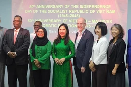 Ambassador Trinh Thi Tam and guests pose for a photo at the ceremony. (Photo published by VNA)