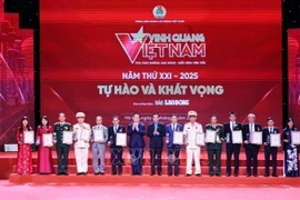 Head of the Party Central Committee’s Commission for Information, Education and Mass Mobilisation Nguyen Trong Nghia (seventh from left), and President of the Vietnam General Confederation of Labour Nguyen Dinh Khang (eighth from left) present the Glory to Vietnam 2025 emblems and certificates to the honoured collectives. (Photo: VNA)