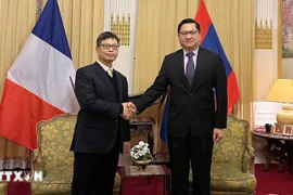 Ambassador Trinh Duc Hai extends New Year wishes of good health, peace and success to Lao Ambassador Kalamoungkhoune Souphanouvong, as well as to all officials and staff of both embassies and their families. (Photo: VNA)