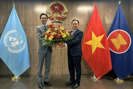 Lao Ambassador to the UN Thongphane Savanphet (right) congratulates Vietnamese Ambassador Do Hung Viet and the Vietnamese Mission on Vietnam's National Day. (Photo: VNA)