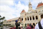 International visitors explore downtown Ho Chi Minh City aboard a double-decker bus. (Photo: VNA) 