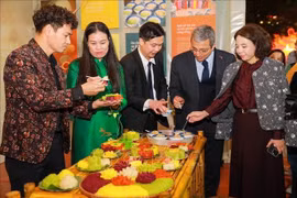 Visitors enjoy Hanoi food at a booth at the festival (Photo: VNA)