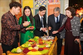 Visitors enjoy Hanoi food at a booth at the festival (Photo: VNA)