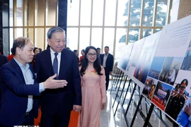Party General Secretary To Lam visits a photo exhibition held by Vietnam News Agency on the sidelines of the national conference on December 19. (Photo: VNA)