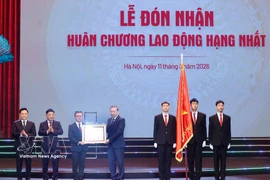 Party General Secretary To Lam presents Nhan Dan newspaper with the first-class Labour Order on March 11. (Photo: VNA)