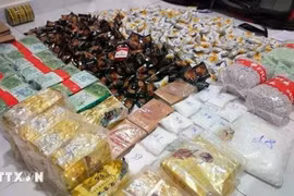 Evidence seized in a crackdown obn a drug trafficking ring that transported and traded more than 30kg of various drugs from Cambodia to Ho Chi Minh City. (Photo published by VNA)