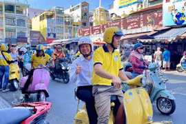 Tourists experience exploring Ho Chi Minh City by Vespa scooter. (Photo: VNA)