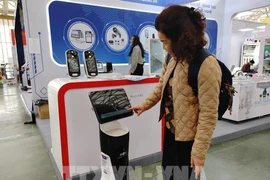 A visitor experience the robot receptionist at the Spring Fair 2026. (Photo: VNA)