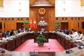 Prime Minister Pham Minh Chinh chairs the meeting with Deputy PMs and leaders of ministries and government agencies on December 5 to discuss the development of free trade zones in localities and a national oil refining, petrochemical, and energy centre at the Dung Quat Economic Zone. (Photo: VNA) 
