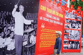 A man visits a Vietnam News Agency-hosted photo exhibition on late President Ho Chi Minh in Hanoi. (Photo: VNA)