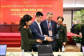 Journalists and editors at work in the Press Centre of the 14th National Party Congress. (Photo: VNA)