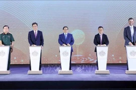 Prime Minister Pham Minh Chinh (middle) and delegates launch the Trump International Hung Yen project on May 21 with the ceremonial button-pressing. (Photo: VNA)
