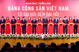 Party General Secretary To Lam (9th from left), together with senior Party and State officials, cut the ribbon to kick off the exhibition in Hanoi on December 26. (Photo: VNA)