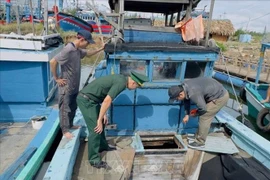 Border guard examines a fishing vessel in Binh Hai commune, Binh Son district in Quang Ngai province. (Photo: VNA)