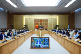 Prime Minister Pham Minh Chinh (centre) chairs a hybrid meeting meeting with ministries, central agencies and local authorities on December 17 to review the implementation of the “Quang Trung Campaign” to rebuild and repair homes that are severely damaged by recent storms and floods. (Photo: VNA)