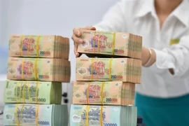 The State Treasury has so far this year continued to expand the coordination of electronic bilateral collection and payment with 20 major commercial banks. (Photo: cafef.vn) 