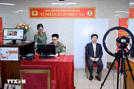 Immigration officers conduct the procedures to issue level-2 electronic identification accounts for a foreigner (Photo: VNA)