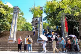 Tourists visit Thien Mu pagoda in Hue. (Photo: VNA)