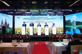 Delegates press the button to activate TH Group's milk processing plant in Borovsk district in Kaluga oblast of Russia on May 11. (Photo: VNA)